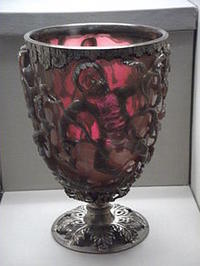 Lycurgus cup on display, lit from behind, showing the red color effect of the dichroic glass on transmitted light. Photo from Wikipedia by JohnBod