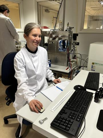 Photo of Rachel Wood sitting at her desk in the lab