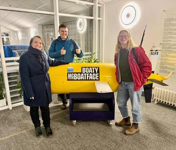 The team pose next to Boaty Mc Boatface submarine