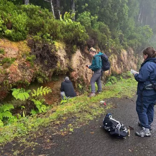 the team assess stratigraphy on a misty mountain road