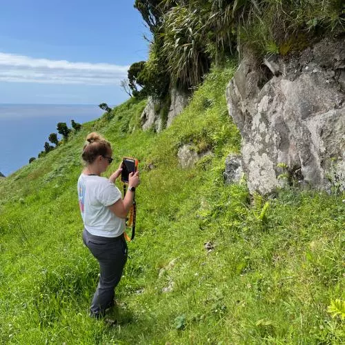 Emma takes a photo of rocks