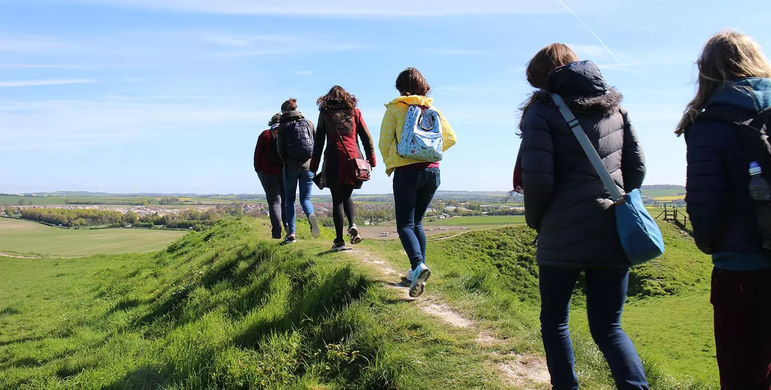 People walking along the mounds at Sarum