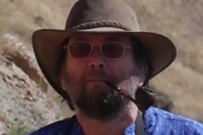 Photo of mark in a hat and smoking his pipe